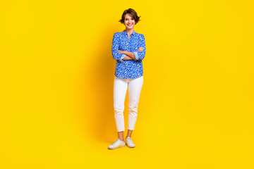 Fototapeta na wymiar Full length photo of cheerful positive lady wear print shirt arms crossed isolated yellow color background