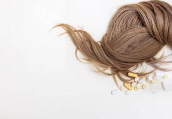 hair care and treatment concept.hair thread isolated with many pills tablets from bottle or in wine...