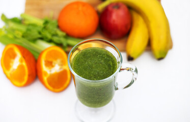 healthy smoothie in glass and fruits all around on wooden board kitchen table and background.slim...