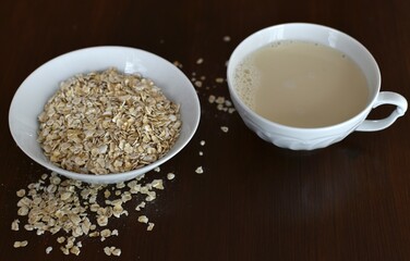 oatmeal and oat milk in a white mug on a wooden table