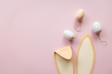 bunny ears and eggs on pink background. easter rabbit concept