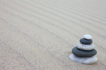 Fototapeta na wymiar L'équilibre fragile des galets sur le sable