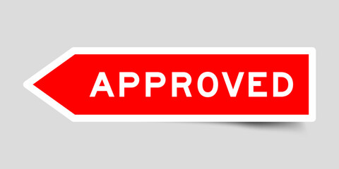 Red color arrow shape sticker label with word approved on gray background