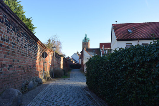 Delitzsch, Germany old town wall and small street with historic tower