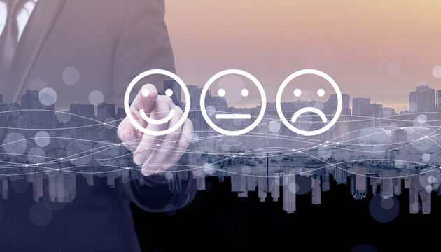 Businessman hand pointing on emoji icons on the background of city silhouette. Communication, technology,  IoT, internet, global, network, futuristic concept - Powered by Adobe