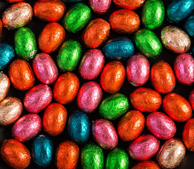 Colorful Easter eggs background. Chocolate Easter eggs texture. Top view