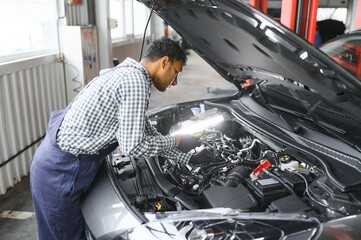 Indian happy auto mechanic in blue suit.