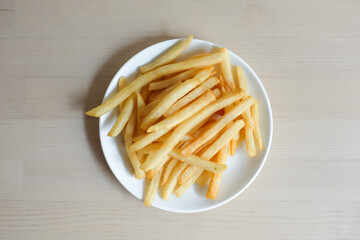 French fries with on wooden background.