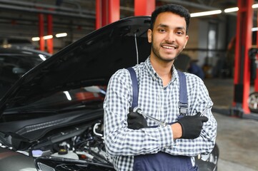Fototapeta na wymiar Handsome Indian Auto Mechanic at car servise