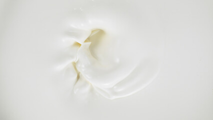 Freeze motion of whirling milk cream, close-up