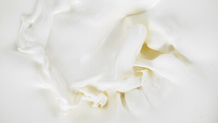 Freeze motion of whirling milk cream, close-up