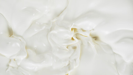 Fototapeta na wymiar Freeze motion of whirling milk cream, close-up