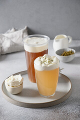 Two Cheese tea with layer of cream cheese foam topped. Vertical format. Close up. Chinese popular asian beverage from oolong and black tea.