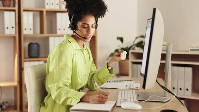 Black woman, call center and consulting or writing by computer for customer service, telemarketing or support at office desk. African female consultant talking and taking notes by PC in contact us