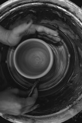 Woman working on pottery wheel creating a bowl