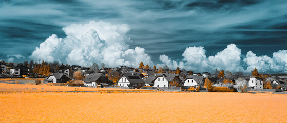 Winter countryside under dramatic blue sky with large fluffy clouds
