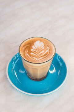 piccolo latte on blue saucer