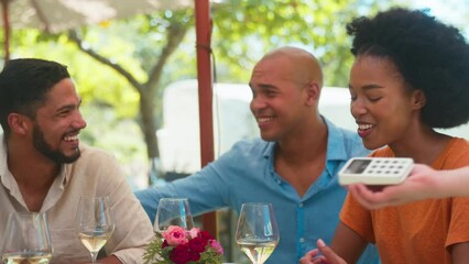 Woman paying bill at outdoor bar or restaurant with friends using contactless app on mobile phone - shot in slow motion - Powered by Adobe