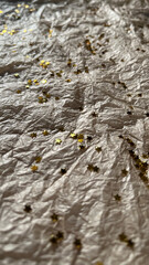 Glitter sparkles shining silver stars on tissue paper background in the sun with shadows. Background