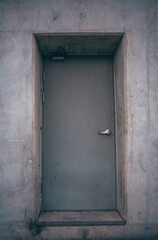 Lonely door deep inside a massive concrete wall