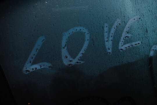 Love title and symbol of heart on car window