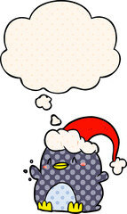 cartoon penguin wearing christmas hat and thought bubble in comic book style