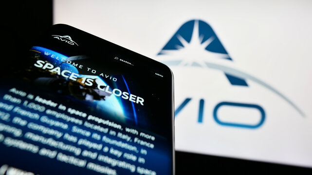 Stuttgart, Germany - 03-25-2023: Mobile phone with website of Italian aerospace company Avio S.p.A. on screen in front of business logo. Focus on top-left of phone display.