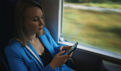 Woman in business suit travelling by the train.