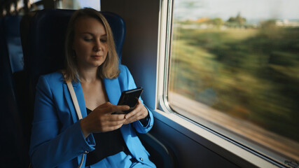 Woman in business suit travelling by the train.