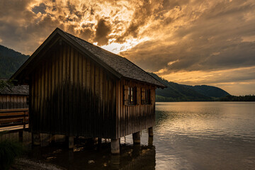 Fototapeta na wymiar wooden hut in the lake Schliersee at sunset