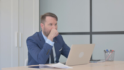 Businessman Shocked by Loss on Laptop and Documents, Paperwork