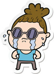 sticker of a cartoon crying woman wearing sunglasses