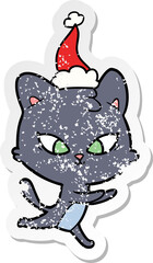 cute distressed sticker cartoon of a cat wearing santa hat