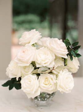 a vase of beautiful white roses