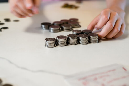 tween girl counting money from her money box
