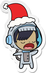 sticker cartoon of a talking astronaut woman wearing santa hat