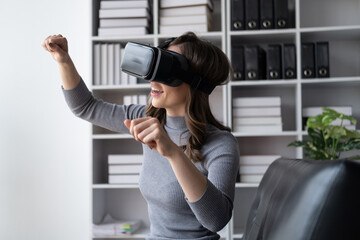Beautiful woman in virtual reality glasses having fun at home.