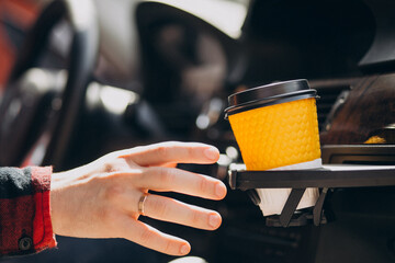 Cup of coffee in a car cup holder