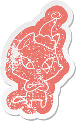 confused cartoon distressed sticker of a cat wearing santa hat