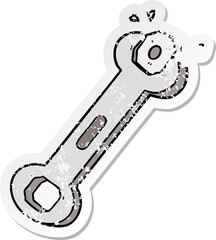distressed sticker of a cartoon spanner turning nut