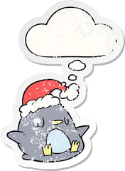 cute cartoon penguin and thought bubble as a distressed worn sticker