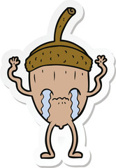 sticker of a cartoon crying acorn
