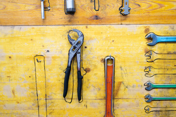 detail of tools fixed with drawing to arrange them on wood in community workshop