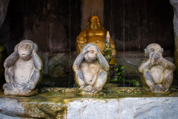 Fototapeta na wymiar Three wise monkeys - see no evil, hear no evil, speak no evil - statues in Thailand