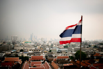 Thailand flag flying over a hazy Bangkok
