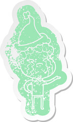 cartoon distressed sticker of a man crying wearing santa hat