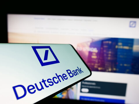 Stuttgart, Germany - 03-25-2023: Mobile phone with logo of German financial company Deutsche Bank AG on screen in front of business website. Focus on center of phone display.