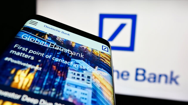 Stuttgart, Germany - 03-25-2023: Smartphone with website of German financial company Deutsche Bank AG on screen in front of business logo. Focus on top-left of phone display.