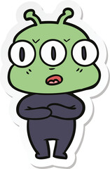 sticker of a cartoon three eyed alien