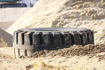 Tires for large trucks dumped in sandy soil